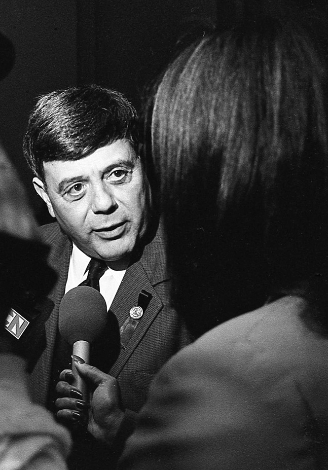 A black and white photo of a Cianci towards the end of his second term responding to a reporter.