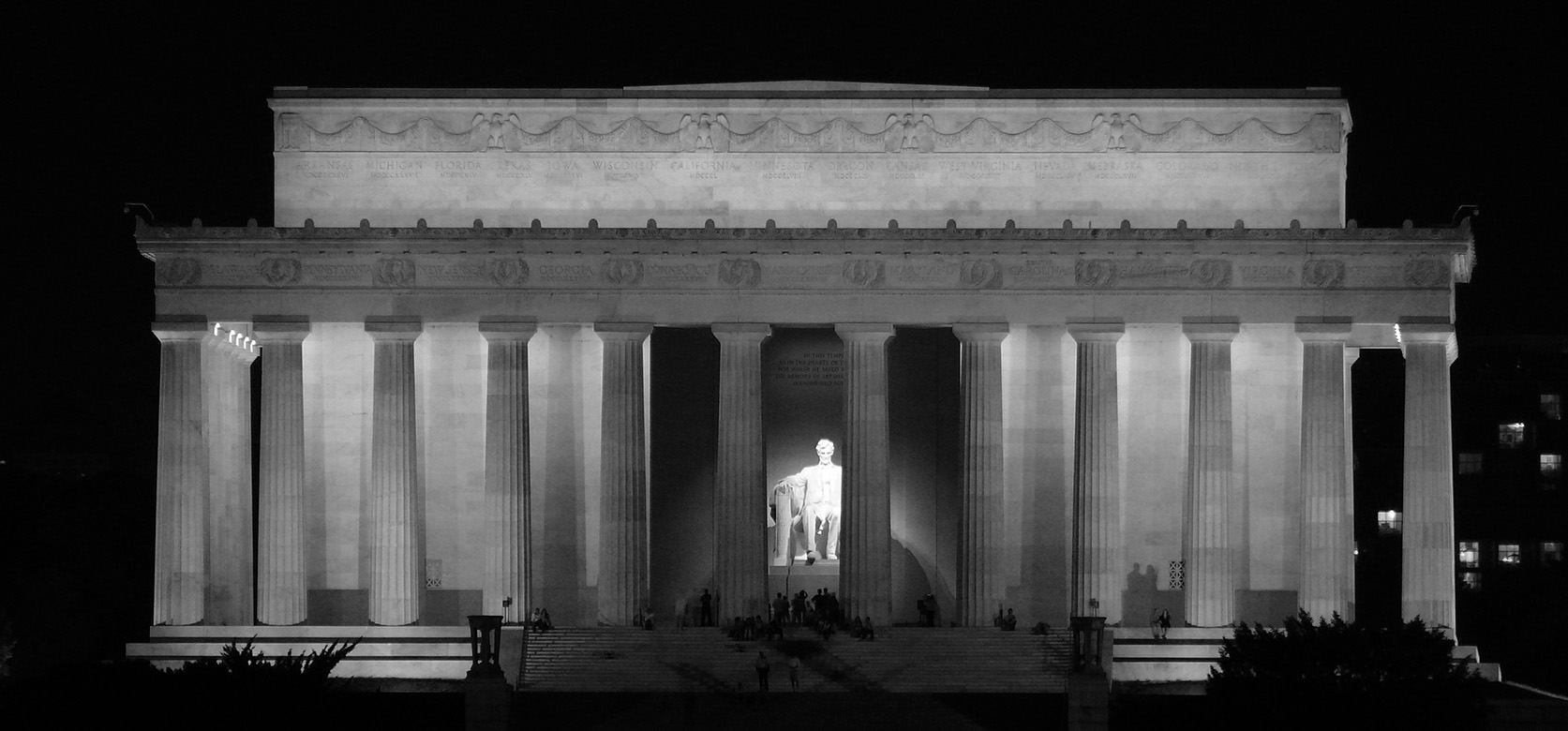 A black and white photograph of the Lincoln Memorial in Washington DC taken at night.
