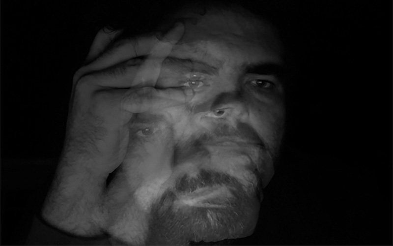 A black and white self portrait of Andrew Goodman created using custom multiple exposure software
